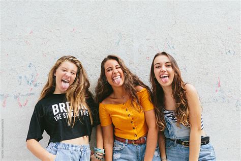 Three Teen Girls Showing Their Tongue To Camera By Stocksy