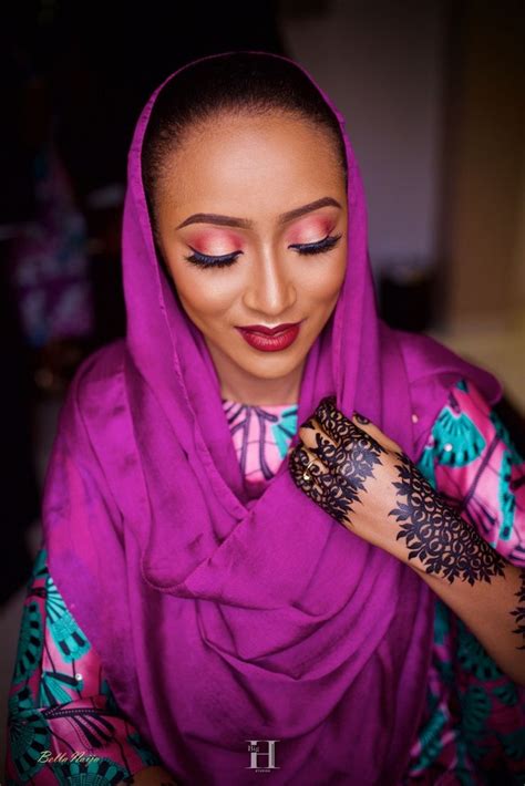 A Woman Wearing A Purple Hijab And Henna
