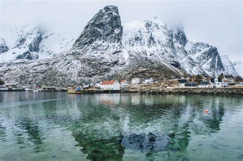 Buildings And Snowcapped Mountains Reine Lofoten Norway Stock Photo