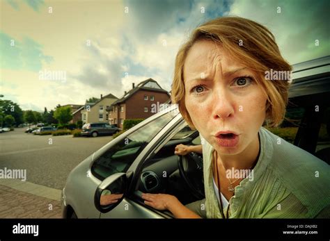 Angry Woman Car Driver Sticking Out Her Head Out Of The Window Stock