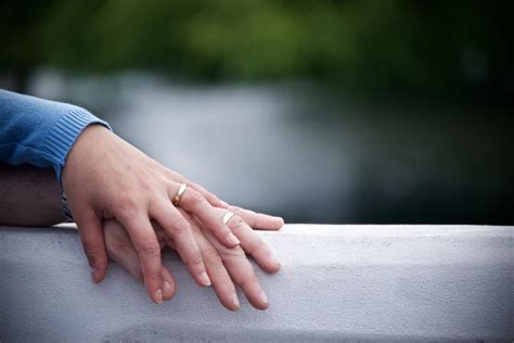 Couple With Wedding Ring Holding Hands Free Photo