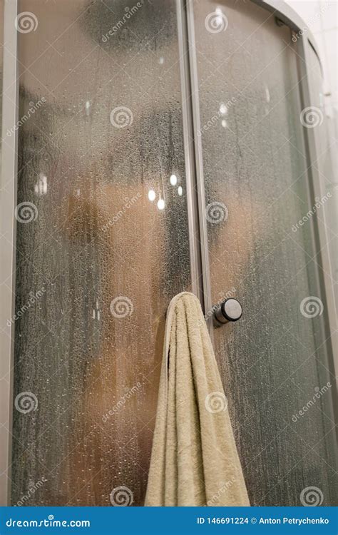 Beautiful Woman In The Shower Behind Glass With Drops Woman In The Shower Behind Glass With