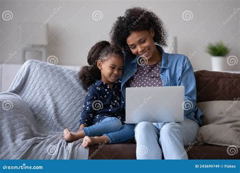 Happy Daughter Girl And Joyful African Mom Reading Online Book Stock Image Image Of Millennial