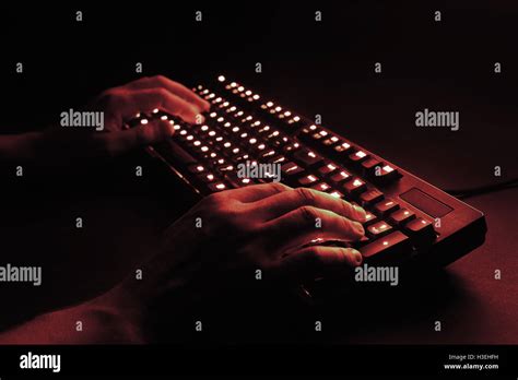 Illuminated Keyboard Male Hands Typing On A Computer Hacker Or