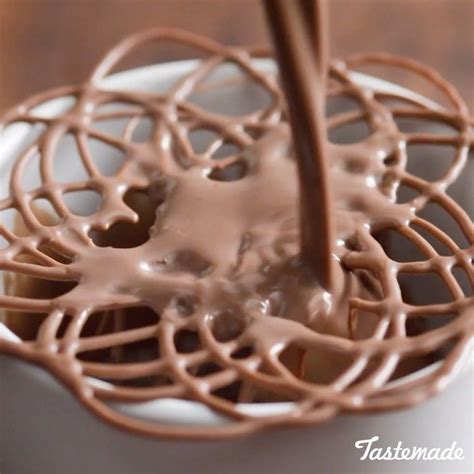 Chocolate Is Being Poured Into A White Cup