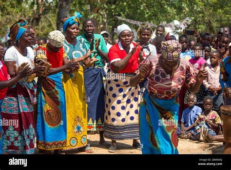 Women Dancing And Singing Dressed In Colorful Traditional African