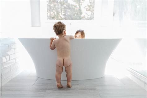 Naked Babe Looking At Her Babe In A Big Bathtub By Stocksy Contributor Jakob Lagerstedt