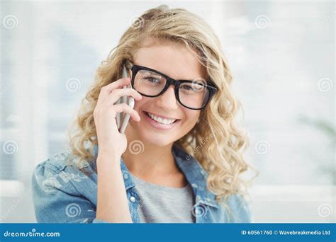Portrait Of Smiling Woman Wearing Eyeglasses While Talking On