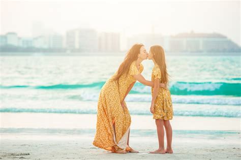Premium Photo Beautiful Mother And Daughter At The Beach Enjoying Summer Vacation