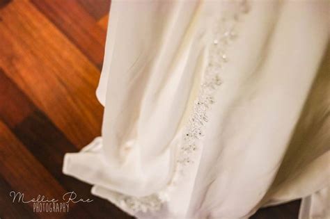 The Back Of A White Dress With Beading On It