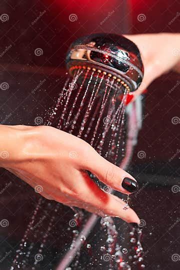 two lesbian girls in the shower shower head with pouring water and a female hand stock image