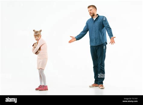 Angry Father Scolding His Daughter At Home Studio Shot Of Emotional