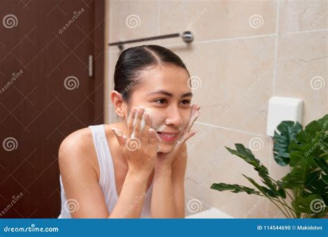 Young Beautiful Asian Woman Washing Her Face With Hands By Soap Stock