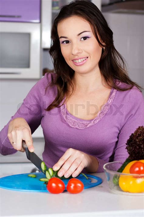 Pretty Woman Cooking Food In The Kitchen Stock Image Colourbox