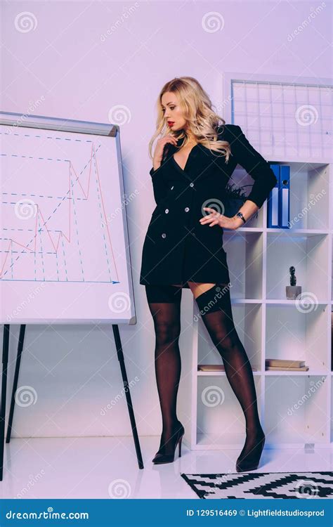 Seductive Businesswoman Standing In Jacket And Stockings Stock Image