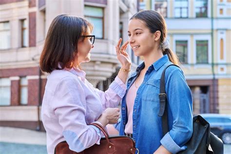 Talking Mom And Teenage Daughter Outdoors On City Street Stock Image