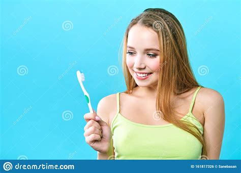 Young Beautiful Woman Is Engaged In Cleaning Teeth Beautiful Smile