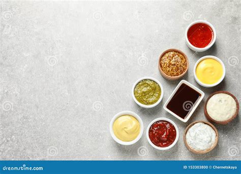 Set Of Different Delicious Sauces On Grey Table Top View Stock Photo