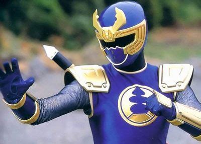 A Man In Blue And Gold Costume Holding His Hands Out To The Side With