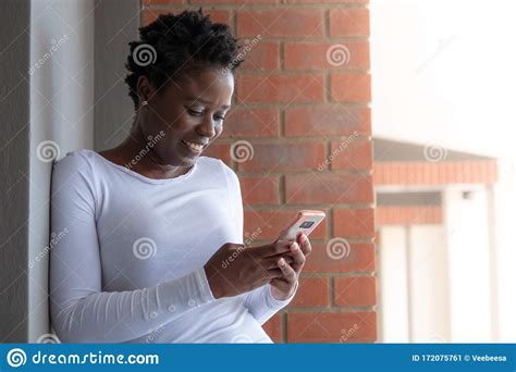 Smiling African Woman Looking At Mobile Phone Stock Image Image Of