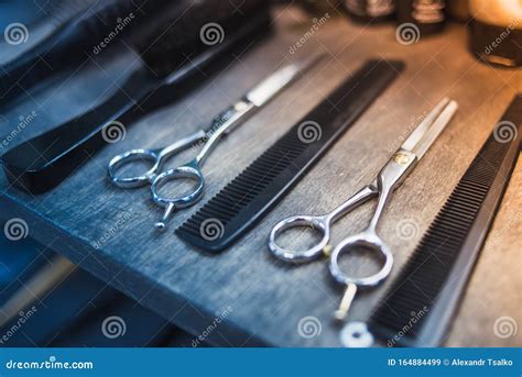 Combs And Scissors For Cutting Hair Lie On A Shelf In A Hairdressing