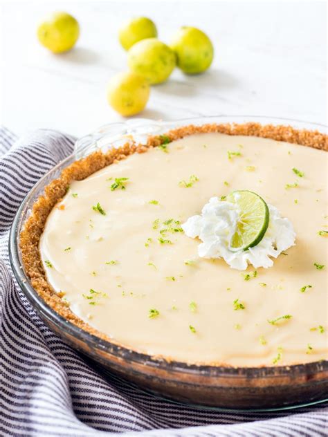 A Pie With Limes And Whipped Cream On Top