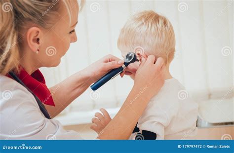 Doctor Examines Ear With Otoscope In A Pediatrician Room Stock Photo