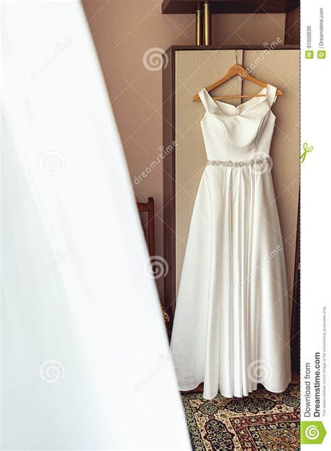 Simple White Wedding Dress On The Rack At The Wardrobe Stock Image
