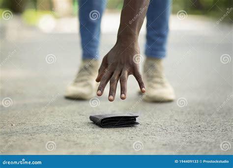 Guy Picking Up A Lost A Lost Purse Wallet Royalty Free Stock Photo Cartoondealer Com