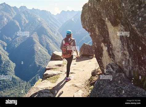 Woman Walk On Mountain Cliff Back View Stock Photo Alamy