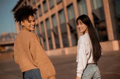 Two Cute Girls Walking Together In The Street Stock Image Image Of