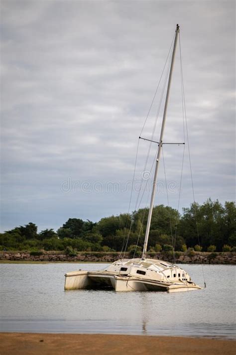 Old Catamaran Lying On The Beach Cloudy Day In Summer Editorial Stock