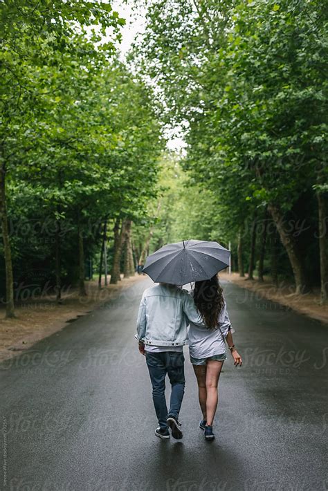Couple Walking Under The Rain By Stocksy Contributor Simone Wave