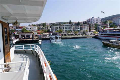 The Water Is Blue And Green As Boats Are In The Harbor Near Buildings