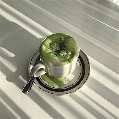 A Cup Filled With Green Liquid Sitting On Top Of A Saucer