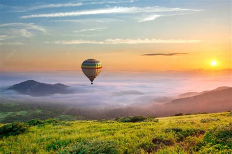 Premium Photo Big Hot Air Baloon Over Idyllic Landscape With Green