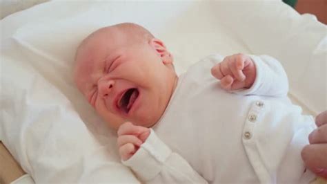 Close Up Of A Cute Newborn Baby Lying On Bed And Crying 3 Free Stock
