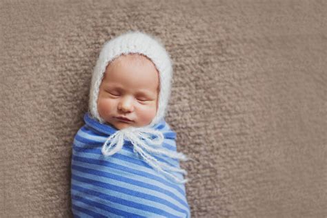 Beautiful Newborn Baby Wrapped Up And Sleeping By Stocksy Contributor
