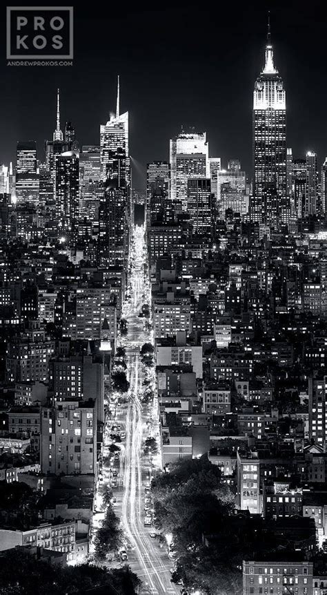 A Black And White Photo Of The City Skyline At Night With Lights On