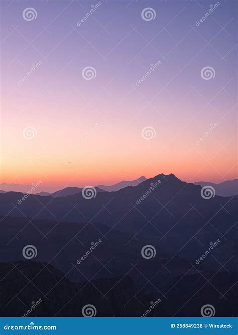 Aesthetic Vertical View Of The Rocky Hills At A Soft Sunset Stock Photo