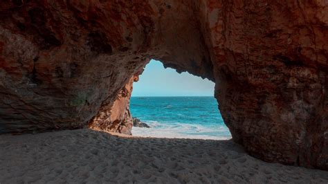 Download Wallpaper 3840x2160 Beach Rock Cave Sea Sand