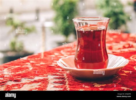 Traditional Turkish Tea In Special Tulip Shaped Glass On Red Tablecloth