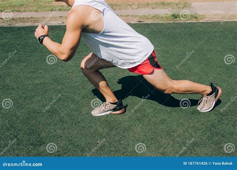 Runner Man Getting Ready To Run Doing Warm Up Dynamic Leg Stretch
