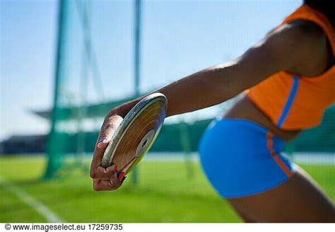 Close Up Female Track And Field Athlete Throwing Discus Close Up Female