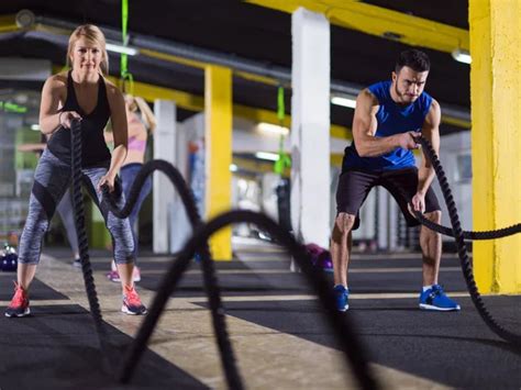 Young Fit Sports Couple Working Out Functional Training Gym Doing Stock