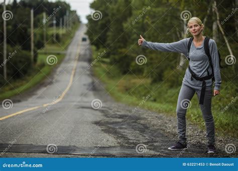 Blonde Woman Hitchhiking Stock Image Image Of Backpack 63221453