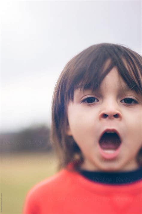 Young Boy Yawning Outside By Stocksy Contributor Kevin Keller Stocksy