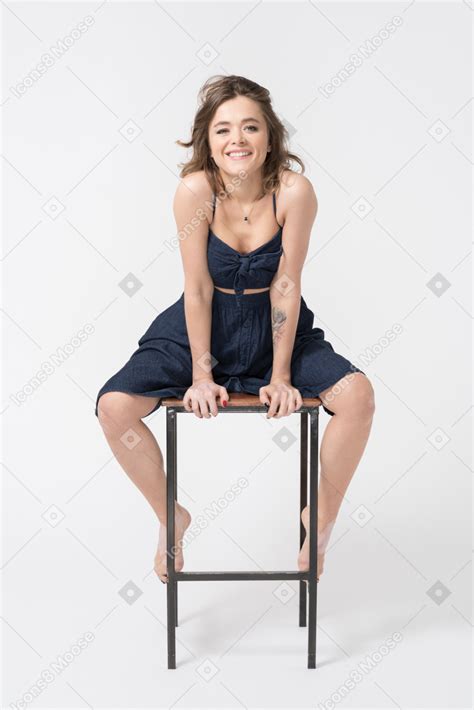 Smiling Woman Sitting With Legs Wide Open Photo
