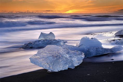 Icebergs Dot The Coastline Along The Black Sand Beach At Dawn In The