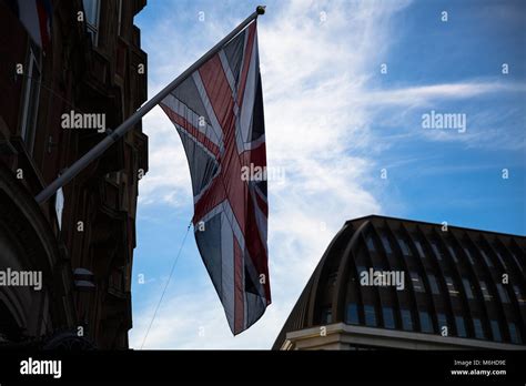 National Flag Of The United Kingdom Union Jack Against A Blue Sky With